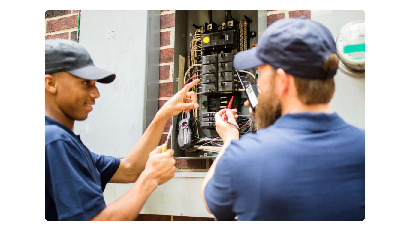 Electricians working on electric panel